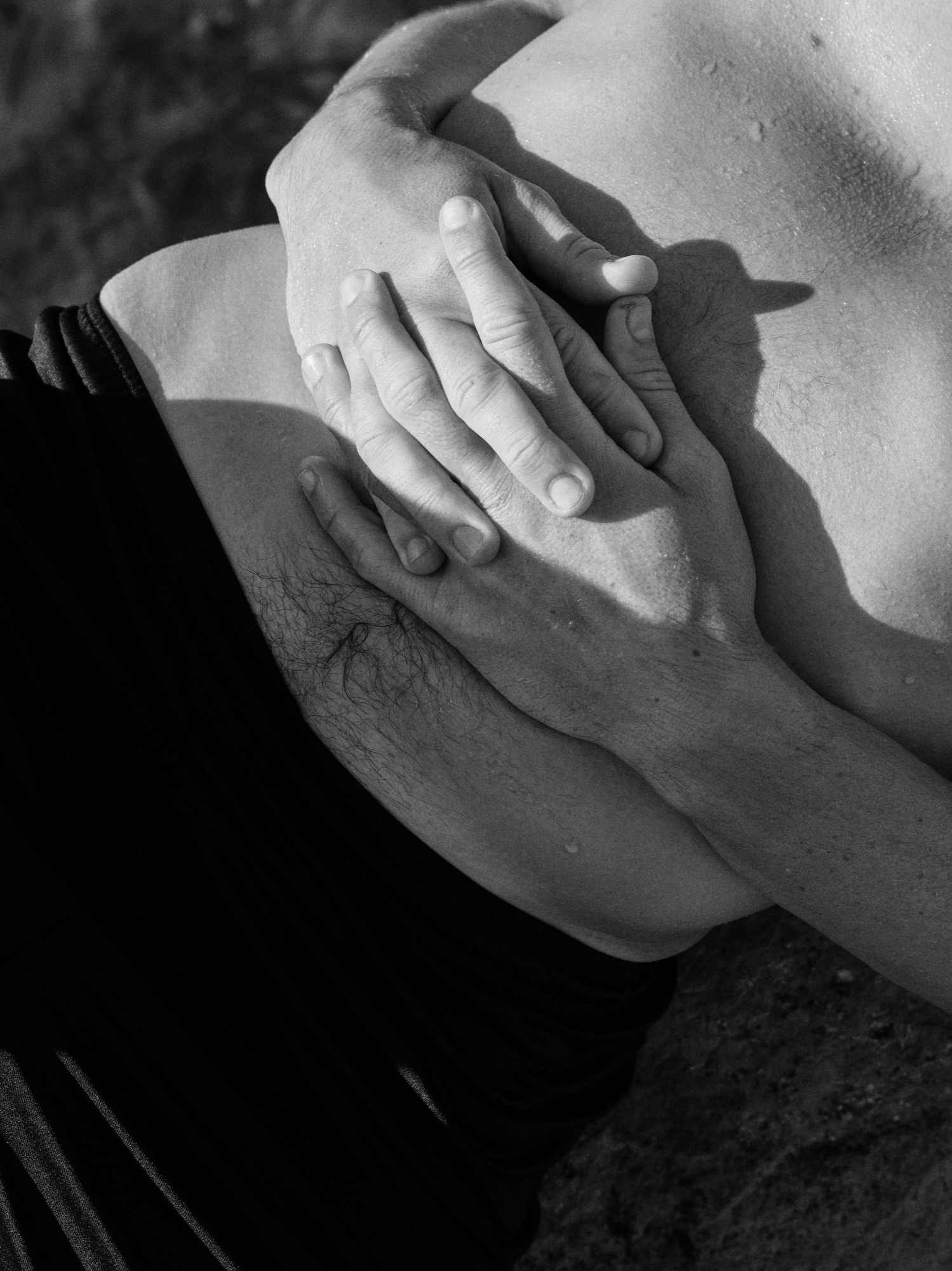 Two hands resting on a belly, feeling the breath