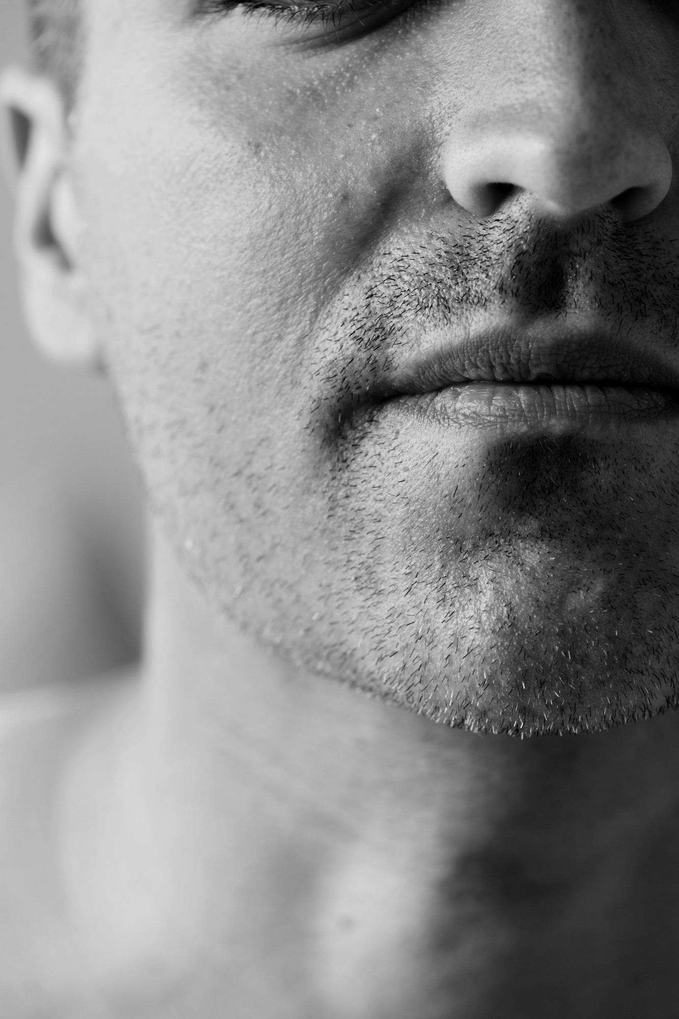 Close up of a mouth and jaw, lips closed on the hum