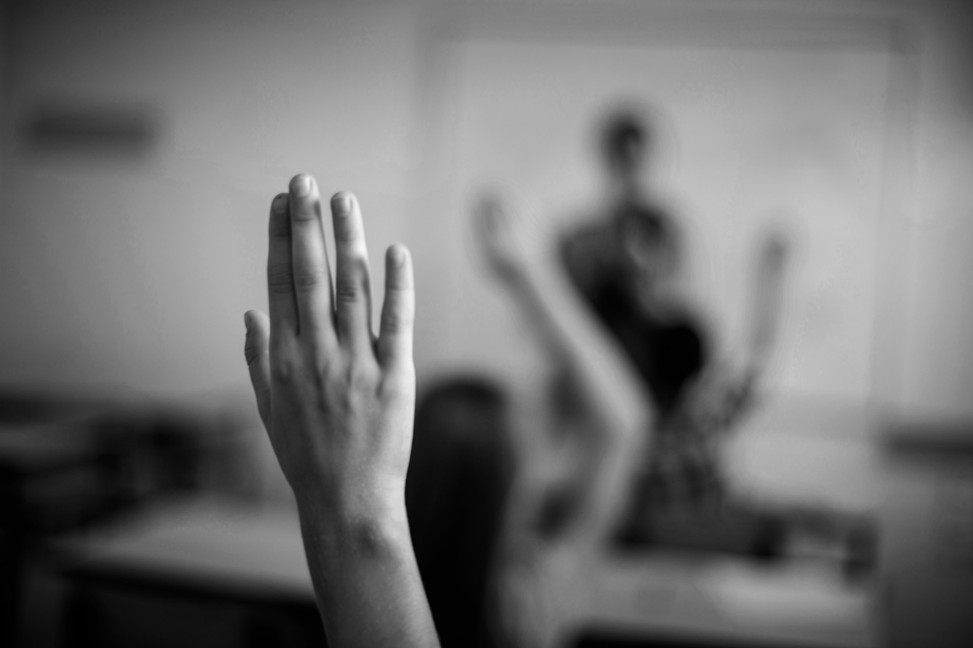 A student raising a hand in class